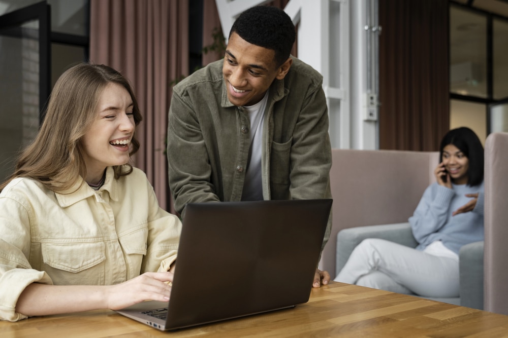 Members of a local association book a municipal room on a laptop