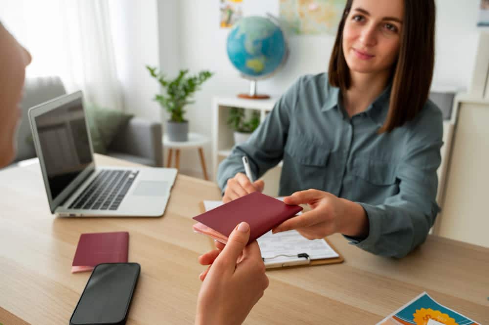 Une agente remet un passeport à une usagère lors de son rendez-vous en mairie